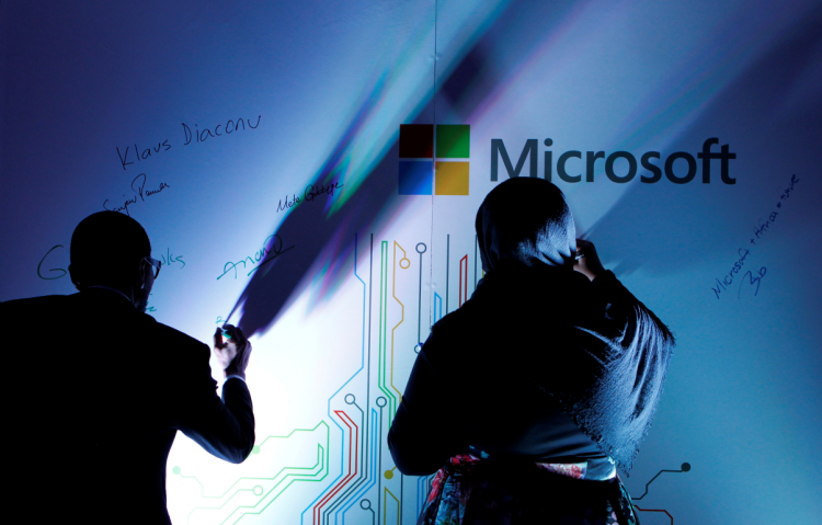Delegates autograph a Microsoft board at the opening of the Microsoft Corp; Africa development centre (ADC)