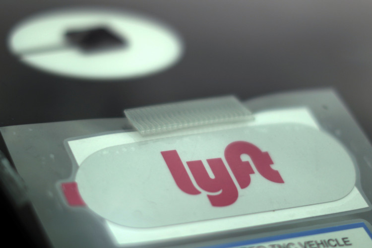 Uber and Lyft stickers are seen on a car windscreen as protesters join an Uber drivers' strike for higher wages at LAX airport in Los Angeles