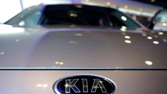 The logo of Kia Motors is pictured on a car at Kia Motors