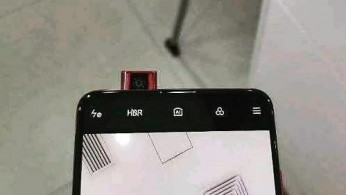 Redmi K20 shown off in an official image with psychedelic design and triple camera setup.