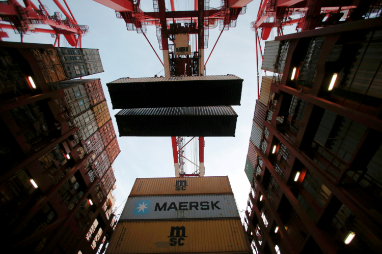 Containers are seen being unloaded from Maersk's Triple-E giant container ship Maersk Majestic, one of the world's largest container ships, at the Yangshan Deep Water Port