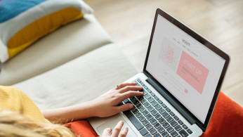 Woman using laptop on her lap