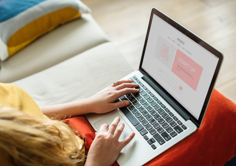 Woman using laptop on her lap