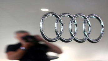 A photographer takes a picture of an Audi