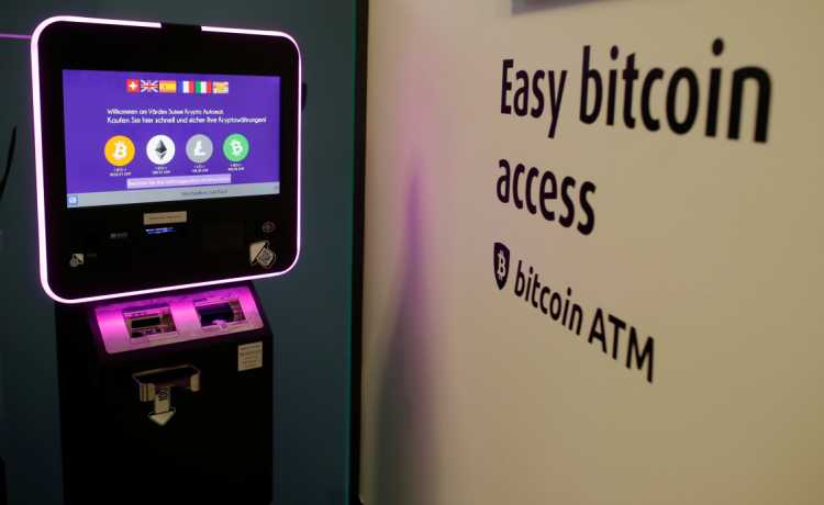 The exchange rates of Bitcoin, Ether, Litecoin and Bitcoin Cash are seen on the display of a cryptocurrency ATM
