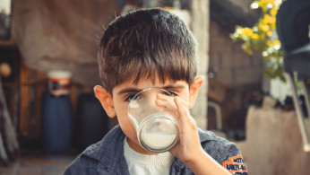 boy drinking a glass of milk
