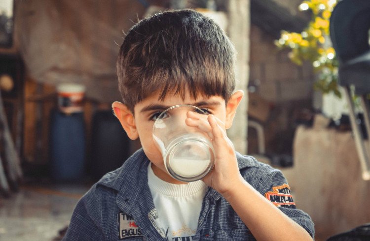 boy drinking a glass of milk
