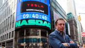 CEO of Tesla Motors Elon Musk poses during a television interview after his company's initial public offering at the NASDAQ market in New York