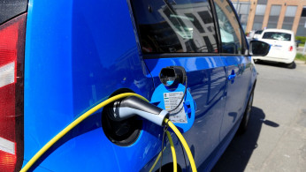 An electric car is charged at a parking lot in Oslo