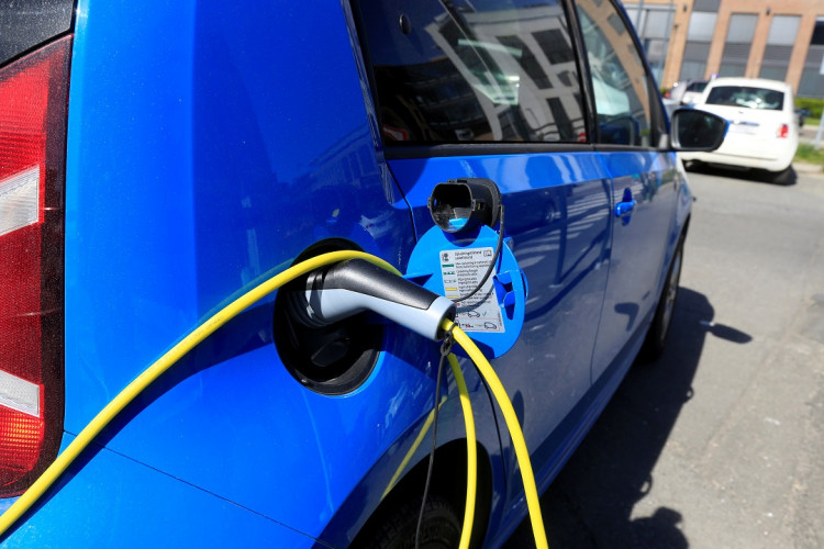 An electric car is charged at a parking lot in Oslo