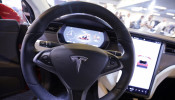 The logo of Tesla carmaker is seen inside a car at the Top Marques fair in Monaco