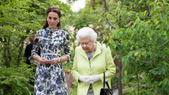 Britain's Queen Elizabeth II is shown around 'Back to Nature' by the designer, Catherine Duchess of Cambridge at the Chelsea Flower Show