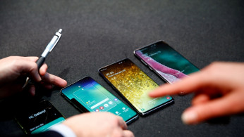 A Samsung employee arranges the new Samsung Galaxy S10e, S10, S10+ and the Samsung Galaxy S10 5G smartphones at a press event in London