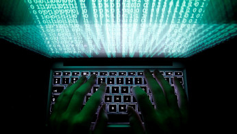 Illustration file picture shows a man typing on a computer keyboard in Warsaw