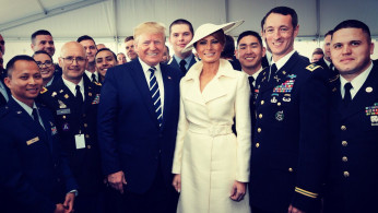 First Lady Melania Trump and President Donald Trump at the D Day Memorial in Normandy France, pictured with some veterans and ladies and gentlemen of the U.S. Army