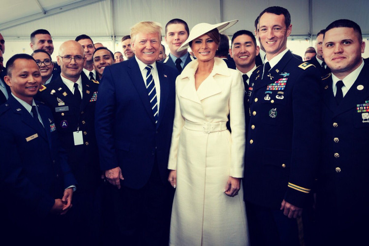 First Lady Melania Trump and President Donald Trump at the D Day Memorial in Normandy France, pictured with some veterans and ladies and gentlemen of the U.S. Army