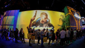 Attendees wait in line during the opening day of E3, the annual video games expo revealing the latest in gaming software and hardware in Los Angeles