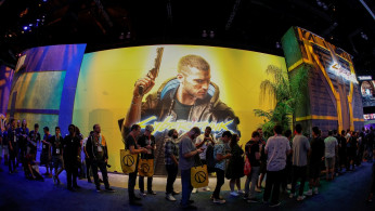 Attendees wait in line during the opening day of E3, the annual video games expo revealing the latest in gaming software and hardware in Los Angeles