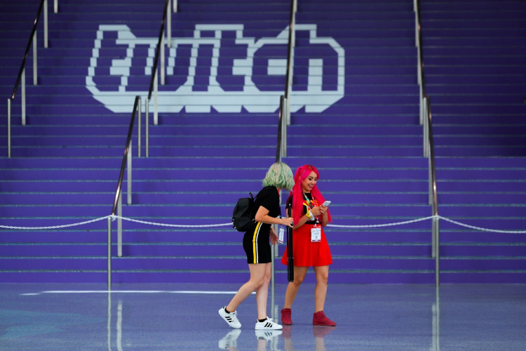 Attendees walk past a Twitch logo painted on stairs during opening day of E3, the annual video games expo revealing the latest in gaming software and hardware in Los Angeles