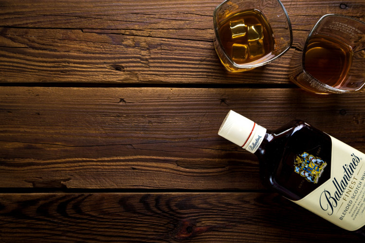 Ballantine's bottle with two rock glasses.