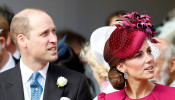 Prince William and Kate, Duchess of Cambridge, look up at the Royal Standard flying from the round tower following the wedding of Princess Eugenie of York and Jack Brooksbank in St George's Chapel, Windsor Castle, near London, Britain October 12, 2018. 