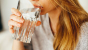 Woman drinking water for healthy benefits