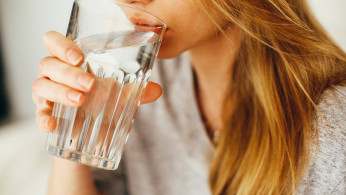 Woman drinking water for healthy benefits