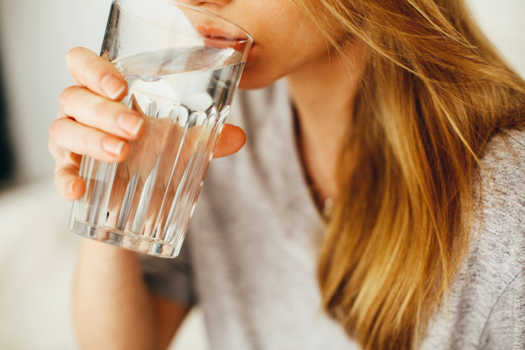 Woman drinking water for healthy benefits