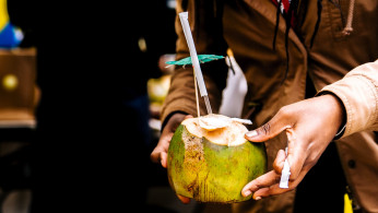 Person holding a coconut.