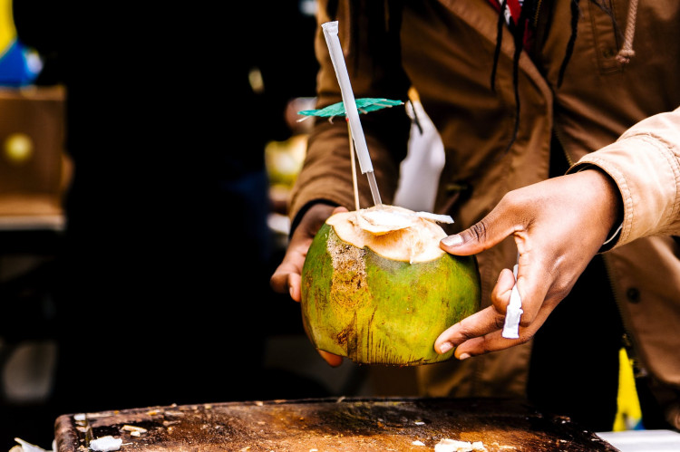 Person holding a coconut.