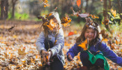 Children playing with dry leaves.