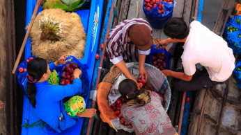 Two Men and Two Women on a Boat With Plastic Bags