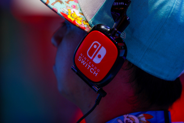An attendee tests out a new game during the opening day of E3, the annual video games expo revealing the latest in gaming software and hardware in Los Angeles