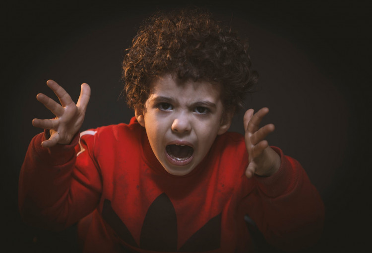 Angry toddler wearing adidas shirt.