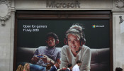 Pedestrians walk past an advertisement outside Microsoft's new Oxford Circus store ahead of its opening in London