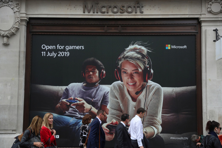 Pedestrians walk past an advertisement outside Microsoft's new Oxford Circus store ahead of its opening in London