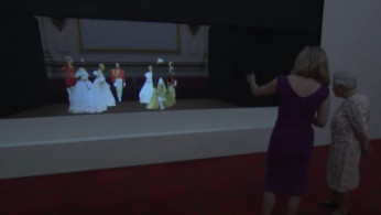 Queen Elizabeth II Watches In Awe Over A 3D Illusion Of A Victorian Ball