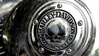 A Harley Davidson logo with a skull is seen on a motorcycle during a funeral service for a 