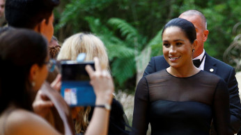 Britain's Meghan, Duchess of Sussex poses for pictures as she attends the European premiere of 