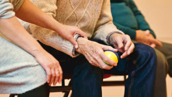 A senior holding a stress ball. 