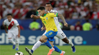 Soccer Football - Copa America Brazil 2019: Philippe Coutinho in action with Peru's Renato Tapia