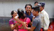 A Guatemalan migrant is embraced by his relatives in Guatemala City upon his arrival from the United States