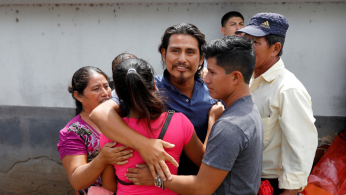 A Guatemalan migrant is embraced by his relatives in Guatemala City upon his arrival from the United States