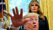 First lady Melania Trump listens as U.S. President Donald Trump speaks to reporters while hosting Team USA for the 2019 Special Olympics World Games in the Oval Office of the White House in Washington, U.S., July 18, 2019.