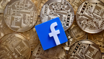 Facebook logo is seen on representations of Bitcoin virtual currency in this illustration picture