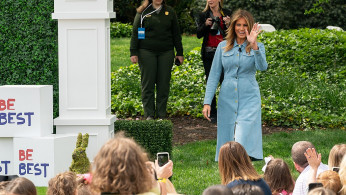 First Lady Melania Trump waves to children on the South Lawn of the White House Monday, April 22, 2019, before reading a story at the reading nook during the 141st White House Easter Egg Roll.