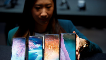 A Samsung employee arranges the new Samsung Galaxy S10e, S10, S10+ and the Samsung Galaxy S10 5G smartphones at a press event in London, Britain February 20, 2019.