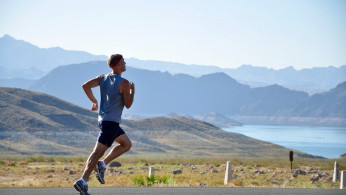 Man running on the side of the road.