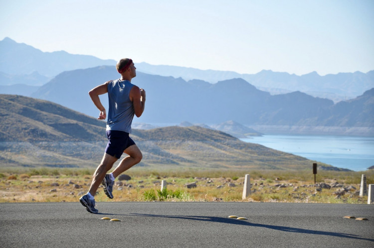 Man running on the side of the road.