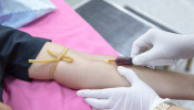 Nurse extracting blood sample.